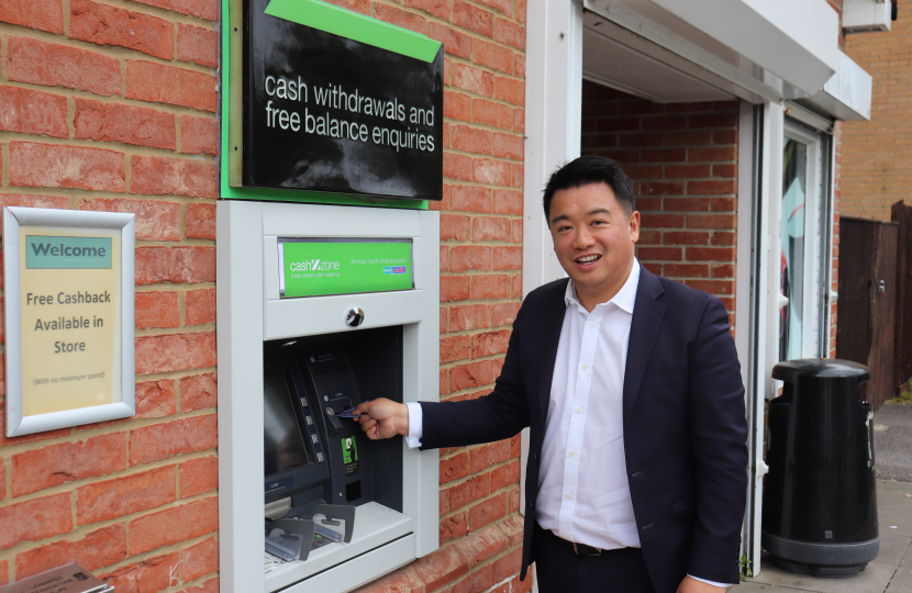Local MP Alan Mak withdraws cash from the free-to-use machine on Snowberry Crescent.