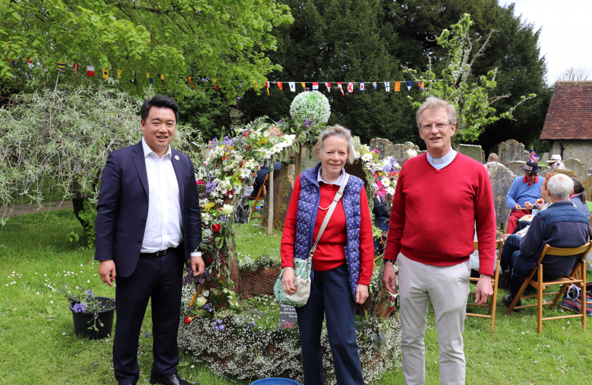 Local MP Alan Mak helped decorate a special floral crown in the church yard [2]