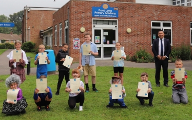 Alan presents his MP School Merit Awards to school children from Front Lawn Primary Academy who were dressed up as part of an event for AgeUK 
