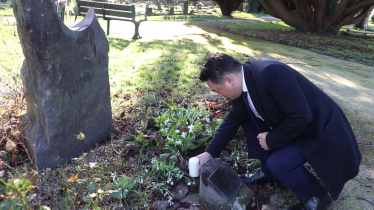 Local MP Alan Mak reflects on the victims of the Holocaust at the Holocaust Memorial in Havant Cemetery.
