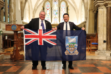 Local MP Alan Mak receives a Falklands Flag from Legislative Assembly Member for Stanley Roger Spink.
