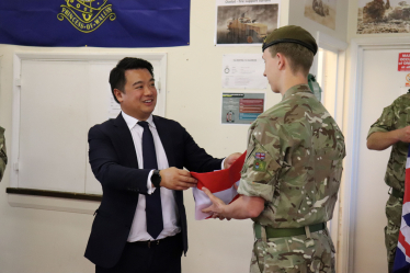 Local MP Alan Mak presents Cadet Watkins with a Union Flag during the visit.
